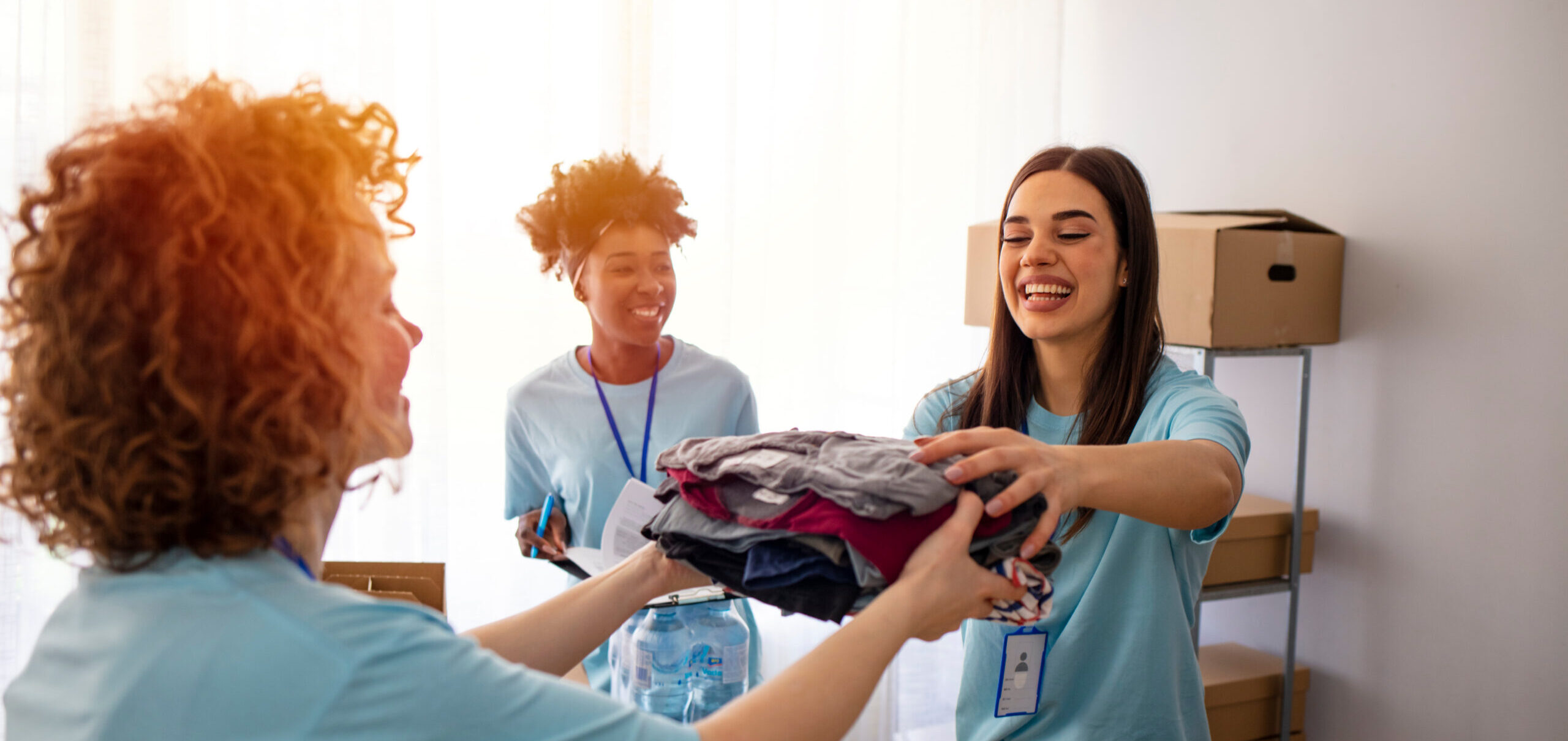 Three happy young women volunteering